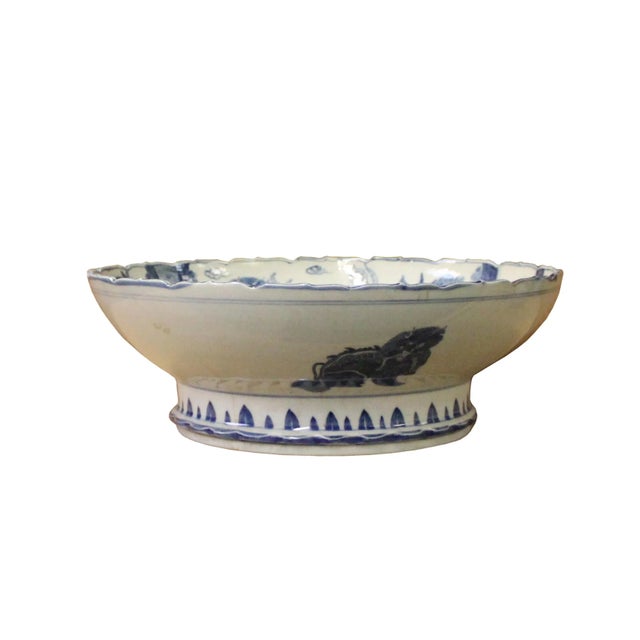 This is a handmade Chinese accent decorative round bowl / deep plate . The blue color oriental floral and Kirin graphic is...