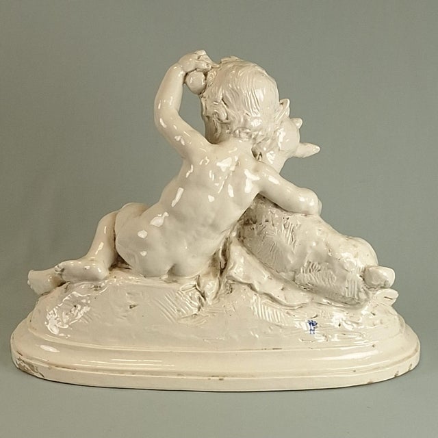 Antique Capodimonte ceramic sculpture of Cherub and Goat, 19thC Size of the sculpture 37 x 50,5 x 23,5 cm. Signed Badessi...