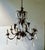 Large Scale Tole and crystal chandelier. Eight arms. Ready to hang with original ceiling cap. Measures: 26" diameter x 28"...