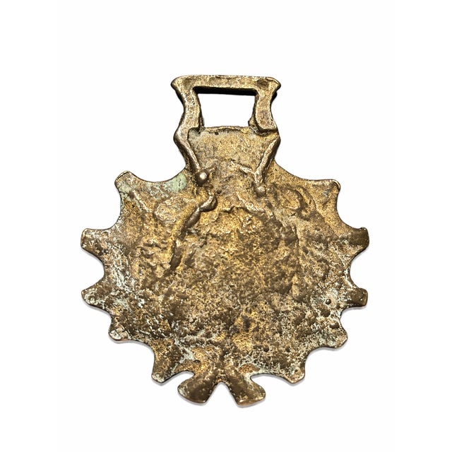 A vintage cast brass horse brass medallion, traditionally used as a decorative harness ornament on horses. This piece...