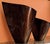 Set of two contemporary, sculptural wooden vases with pronounced grain and a visually fluid finish. They are teardrop-...