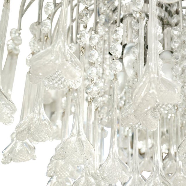 A “flower rain” chandelier Italian design by Cenedese, 1960s. Flower shaped clear blown glass components on a chrome...
