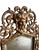 Solid Brass Frame with Filigree work in an arch shape with a mask of Bacchus at the crest. Beveled and antiqued mirror....
