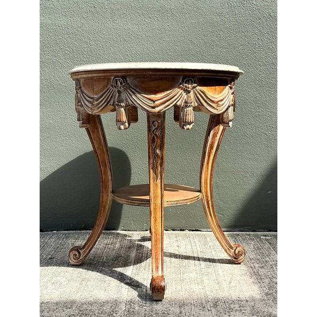 This exquisite Louis XVI style side table is a masterful display of Neoclassical elegance, featuring a hand-carved apron...