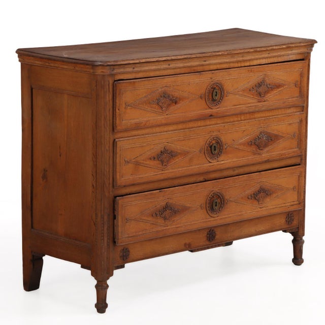 A handsome French oak commode dating to circa 1800, featuring three drawers adorned with distinctive diamond-carved panels...