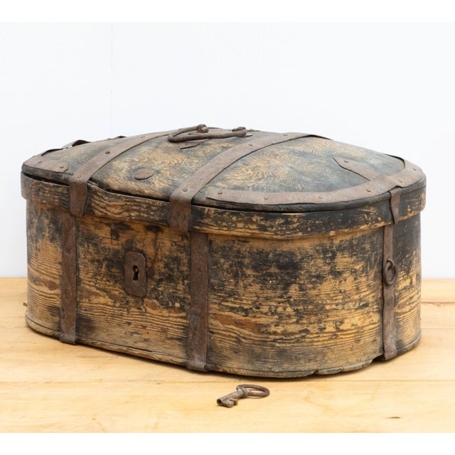 This rustic Swedish metal strapped box, dating back to at least 1820, exudes an undeniable charm. Crafted from the sturdy...