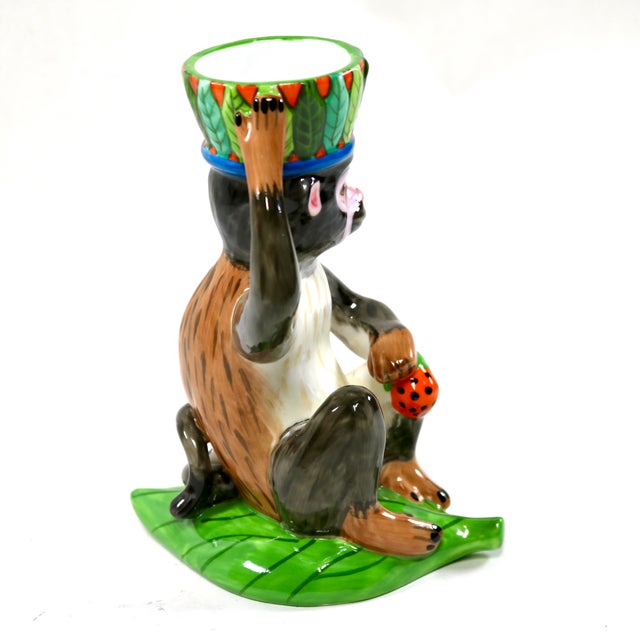 The Lynn Chase Monkey Business rare figural candle holder is a vibrant porcelain piece, hand-painted with a playful jungle...