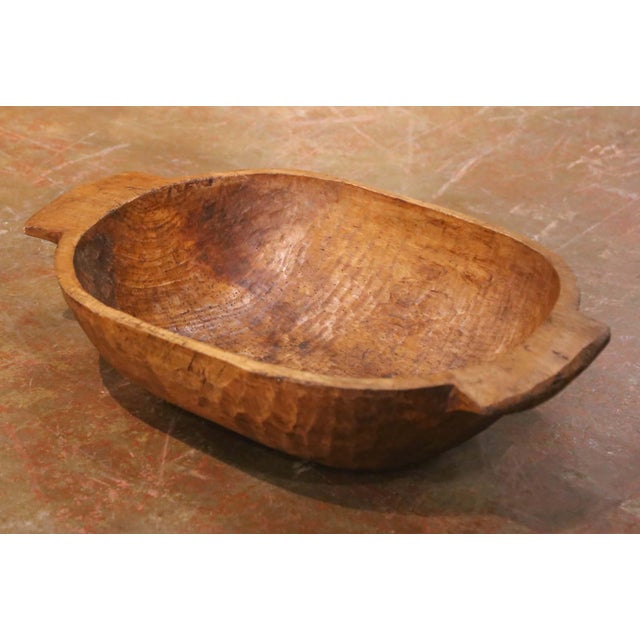 This authentic antique French dough bowl, hand-carved from a single solid block of elm circa 1880, exemplifies the...