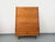Vintage 1960s bookcase display unit, made of wood with black metal legs, featuring six shelves for books and four drawers...