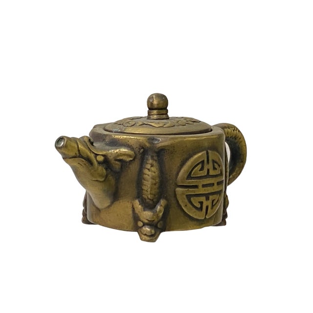 This is a handmade quality piece of metal teapot in bronze color finish with a round shape with dragon motif accents. It...