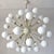 Italian sputnik chandelier with 40 glossy white Murano glass globes mounted on brass frame in lacquered polished brass...
