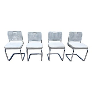 Vintage Set of Four Chrome Cantilever Dining Chairs With White Woven Rattan Backs For Sale