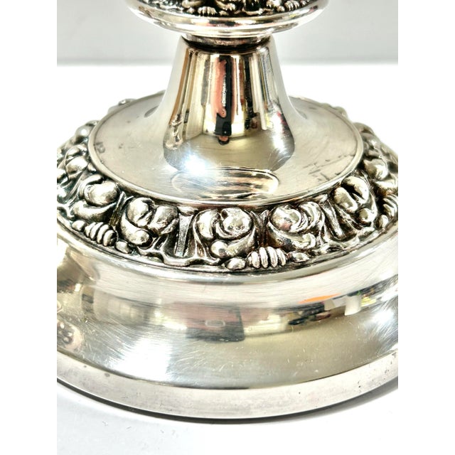 A lovely pair of vintage silver plated candlesticks by Lanthé of England, featuring elegant embossed detailing around the...