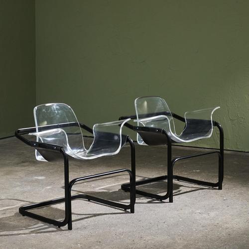 This pair of cantilever lounge chairs was designed by Paolo Tilche in the 1970s. The chairs have a black steel frame with...