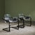 This pair of cantilever lounge chairs was designed by Paolo Tilche in the 1970s. The chairs have a black steel frame with...