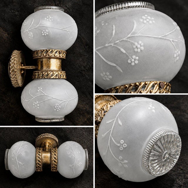 A sophisticated blend of Art Deco elegance and vintage classical charm, this wall sconce showcases ornate brass detailing,...