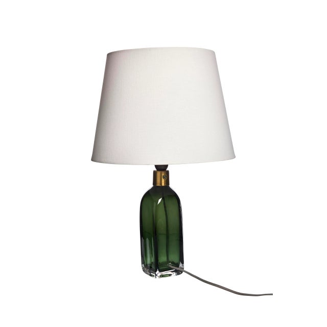 The lamp have a stunning green color with brass details. This piece has an attribution mark, I am sure that it is...