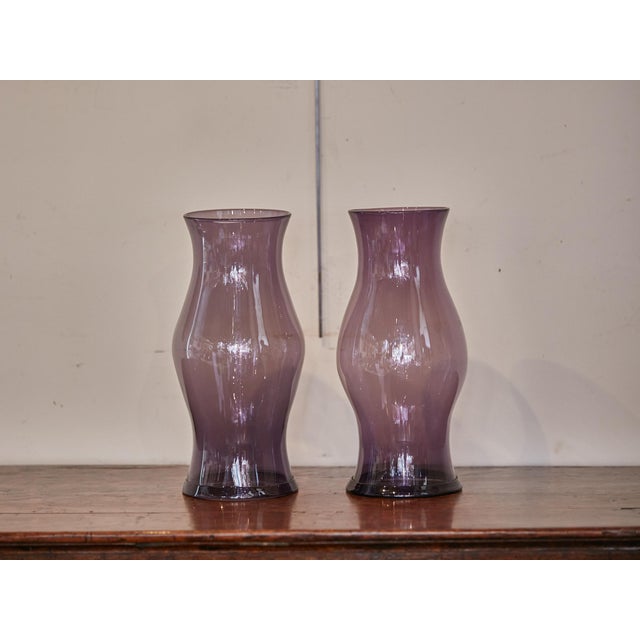 A pair of Midcentury American Amethyst color glass hurricane lamp shades. Evoke a sense of Midcentury magic in your home...