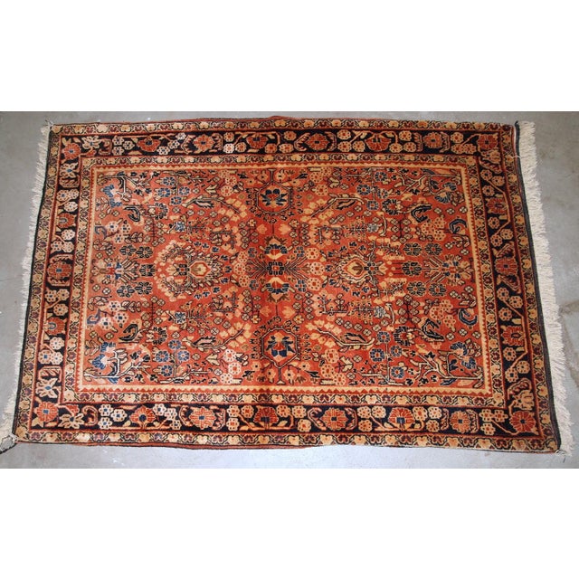 Handmade antique Persian Sarouk rug in original good condition. The rug is from the beginning of 20th century made in red...