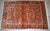 Handmade antique Persian Sarouk rug in original good condition. The rug is from the beginning of 20th century made in red...