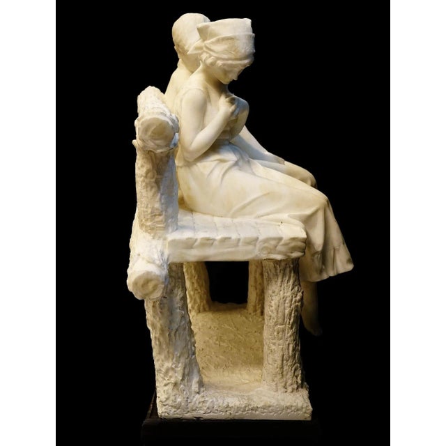 Fine alabaster sculpture of a young couple seated on a bench, attributed to the Italian master, Umberto Stiaccini, active...
