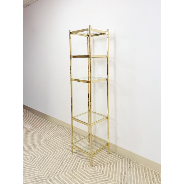 This glamorous brass and glass 5-tier shelf is a dazzling vintage Hollywood Regency and mid-century modern treasure. The...