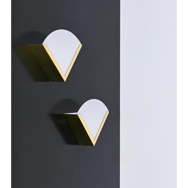 Gorgeous Mid-Century sconces made in brass and white acrylic. These elegant wall lamps were designed in Italy during the...