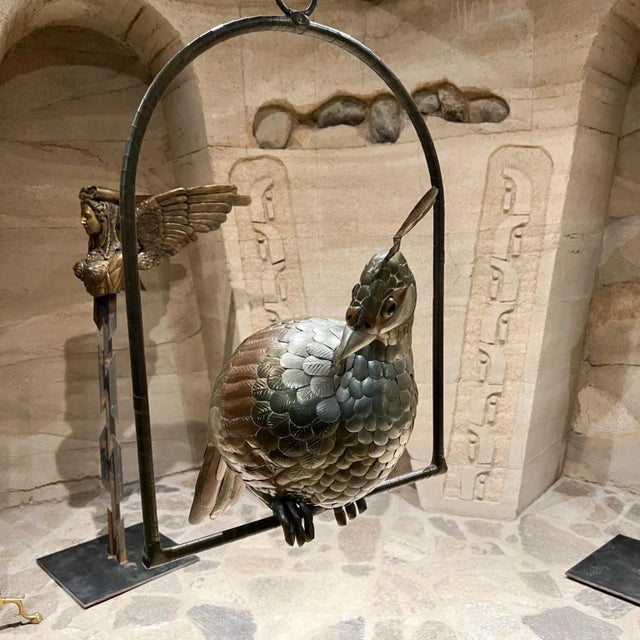 AMBIANIC presents 1970s Mexico Sergio Bustamante Hanging Metal Parrot Cockatoo Bird perched on a Swing. Maker signed and...