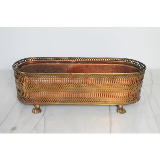 Vintage oval elongated, footed brass and copper reticulated planter with ribbed band and small decorative paw feet....