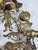 A distinctive all-holiday wreath featuring an assortment of miniature brass animals and seasonal figures, finished with a...