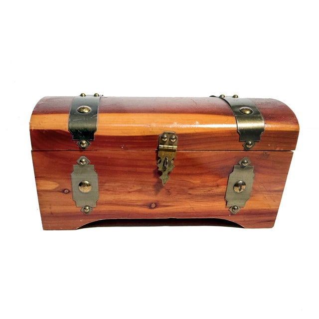 Beautifully crafted from aromatic cedar, this vintage miniature steamer trunk captures the charm of early travel trunks in...