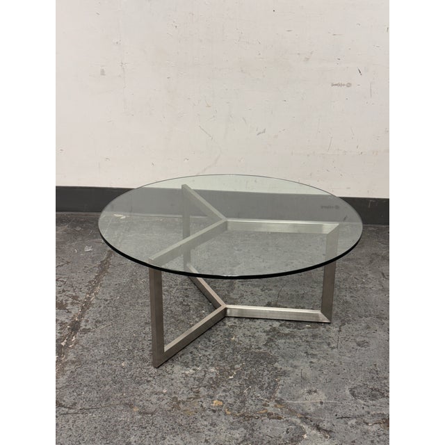 Design Plus Gallery presents a Classic Coffee Table from Room & Board. This modern table pairs a clear round glass top...