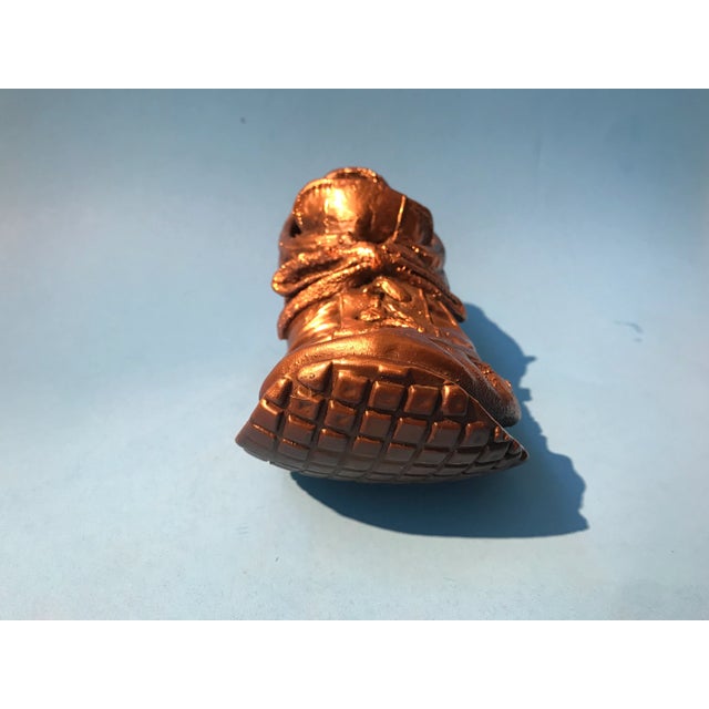 A marvelous bronze sculpture of a 1970s Nike running shoe, masterfully rendered with exceptional detail and craftsmanship....
