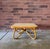 Vintage 1970s rattan coffee table with a sculptural bent-rattan base and softly rounded square top. The warm honey-toned...