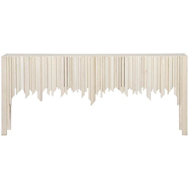This handcrafted Elm sideboard's face and sides are adorned with hand-carved strips of bleached wood, each carefully...