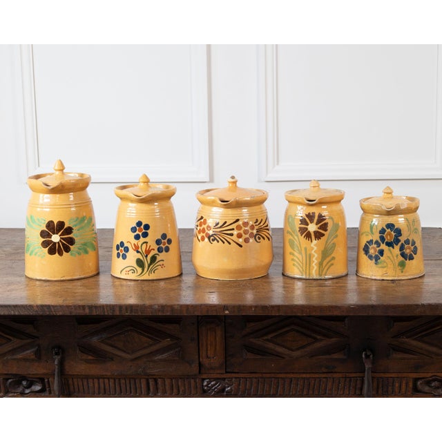 Charming 19th-century French terracotta pottery vessels, each finished in a warm ochre-yellow glaze and decorated by hand...