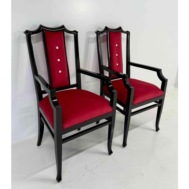 Refined pair of Italian armchairs distinguished by a strong yet elegant presence. The structure is crafted from black...