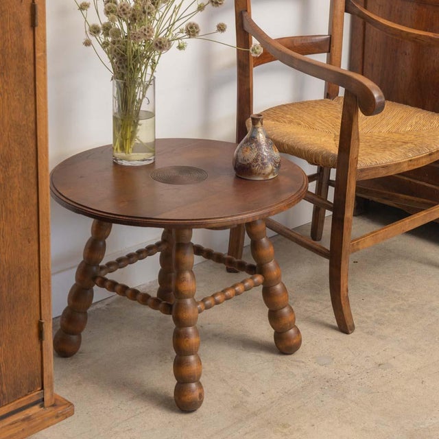 Beautiful carved wood side table by Charles Dudouyt from France, 1940s. Circular top has beautiful carved ring detail and...