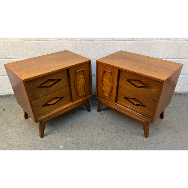Add distinctive mid-century character to your bedroom with this exceptional pair of walnut and burl wood nightstands....