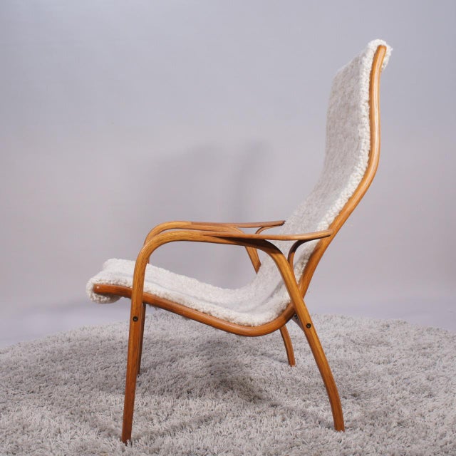 Chair is reupholstered in sheepskin and wood's surface is refinished. This piece has an attribution mark, I am sure that...