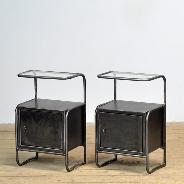 This set of iron bedside tables with a glass top exudes history and style. Originally from a 1950s hospital, they have...
