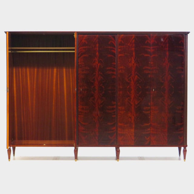 Large vintage mid century 5-door wardrobe in flamed mahogany from the Art Deco period, 1920s-1930s. The wardrobe rests on...