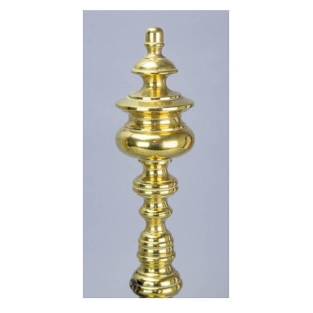 A vintage New England fireplace andirons and tool set, which includes: (i) a pair of brass turned andirons; (ii) and a set...