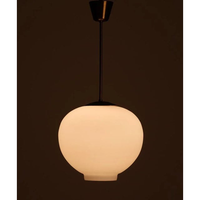 Swedish glass and brass pendant by Böhlmarks, 1950s. Very good condition. This piece is attributed to the mentioned...