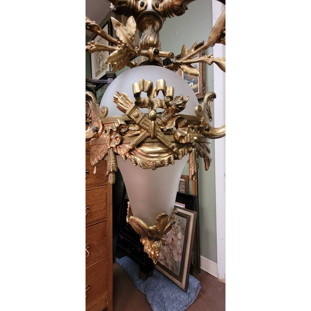 Superb antique guilt bronze and frosted glass three light Chandelier. Features three candlelit arms held together by a...