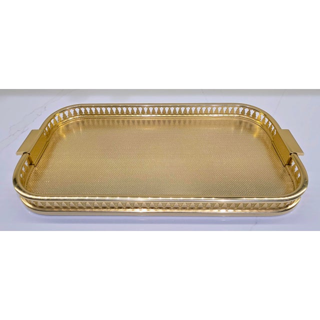 Bring polished Hollywood Regency style to a bar, vanity, coffee table, or dining setting with this elegant vintage gold-...
