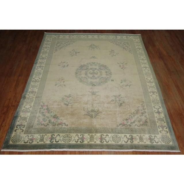 A vintage 20th century chinese rug with a medallion design on a sand/biege. Professionally Cleaned and able to endure...