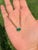 This pendant necklace features a 1.99 carat emerald set in 14K yellow gold. The emerald measures approximately 9 x 7 mm...