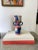 Hand-painted urn style vase with geometric abstract shapes throughout. This vase has unexpected rounded handles at the...