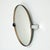 Round pivot wall mirror produced in France during the 1970s, presumably by Allibert. The mirror features a thin smoked...